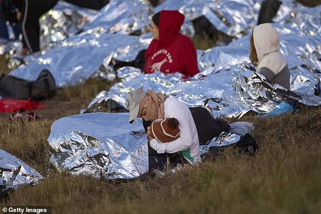 Mothers with children belong to the large group of asylum seekers.  Here a mother cradles her child in the cold