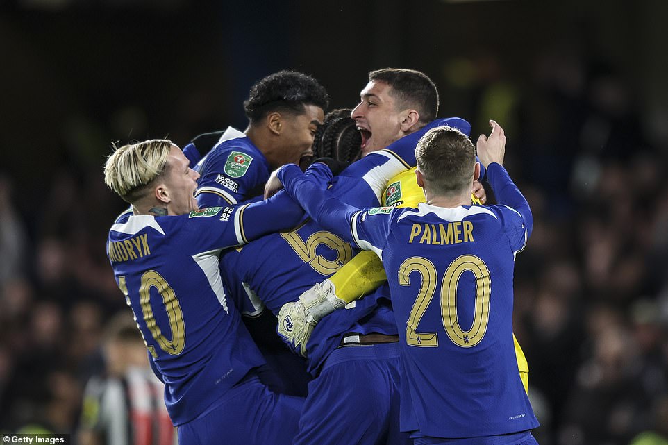 Petrovic is congratulated by his jubilant Chelsea teammates after his save from Ritchie in the penalty shootout