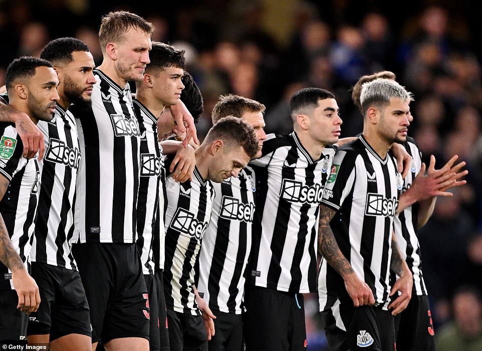 Trippier is consoled by his Newcastle teammates after his penalty shootout miss during the Carabao Cup match