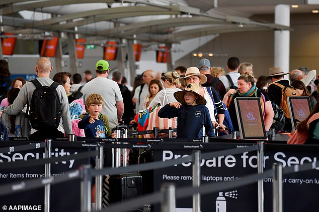 AFP officials have urged travelers to do the right thing during the busiest travel period of the year (stock photo of travelers at Sydney Airport)