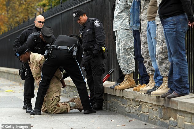 Smith is arrested here after handcuffing himself to the White House fence to protest a policy against LGBTQ soldiers