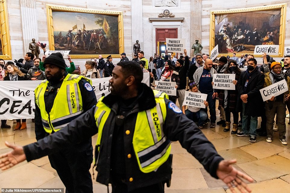 They sang and were placed in handcuffs on the ground in front of statues of iconic American figures, including George Washington, Dwight Eisenhower, Ronald Reagan and Harry Truman.  The group also demanded that Congress drop Biden's $110 billion 