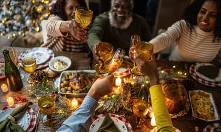 Family toasting Christmas dinner at home