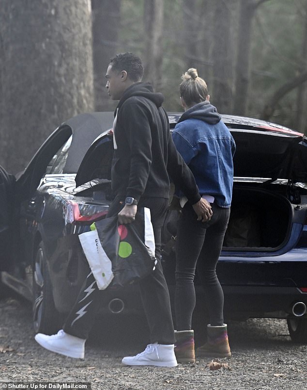 They spent the weekend in a rented cottage and checked it out on November 13.  Holmes patted Robach's butt as she loaded the car.