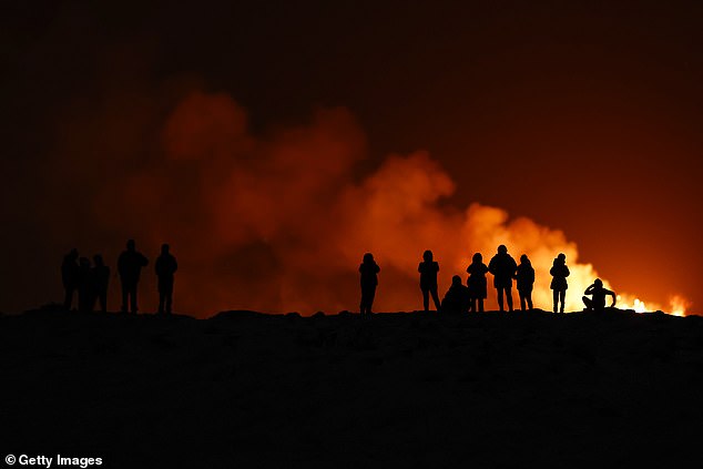 People view the volcano on the Reykjanes Peninsula in southwestern Iceland