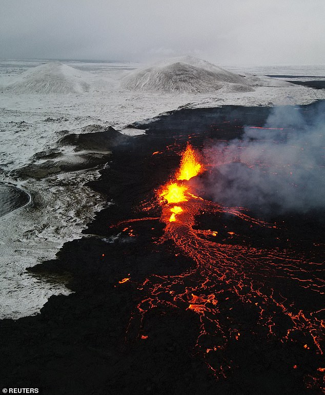 A drone photo shows lava spewing from the volcanic eruption site