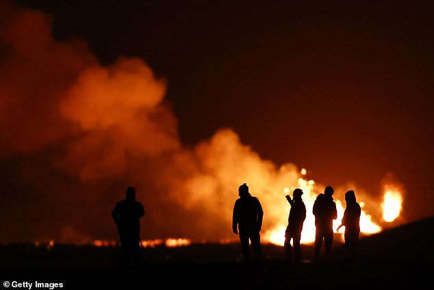 People view the volcano on the Reykjanes Peninsula in southwestern Iceland, which erupted after weeks of intense earthquake activity