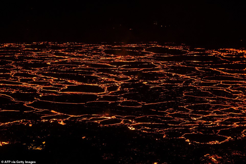 Molten lava emerges from a fissure on the Reykjanes Peninsula, 3 km north of the evacuated town of Grindavik, in western Iceland, on December 19.