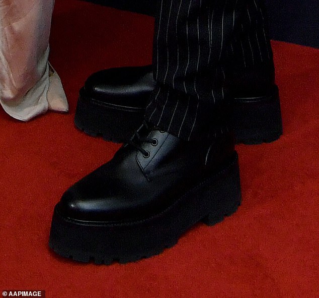 Unfortunately, despite a significant boost, the blonde country crooner still couldn't match his wife's formidable height.  Pictured: Urban's chunky red carpet shoes