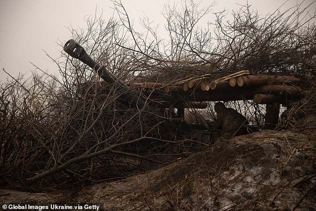 A crew member of the 122mm self-propelled howitzer 2S1 Gvozdika prepares the howitzer for firing on Russian positions near the occupied Ukrainian city of Bakhmut on December 18