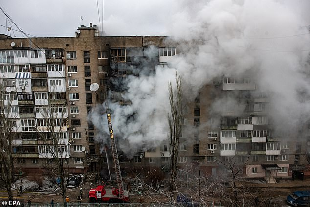 Firefighters work at the site of a damaged building after the shelling in Donetsk