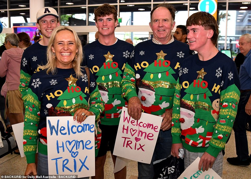 The family of a young woman returning home after a gap year are seen wearing matching Christmas jumpers