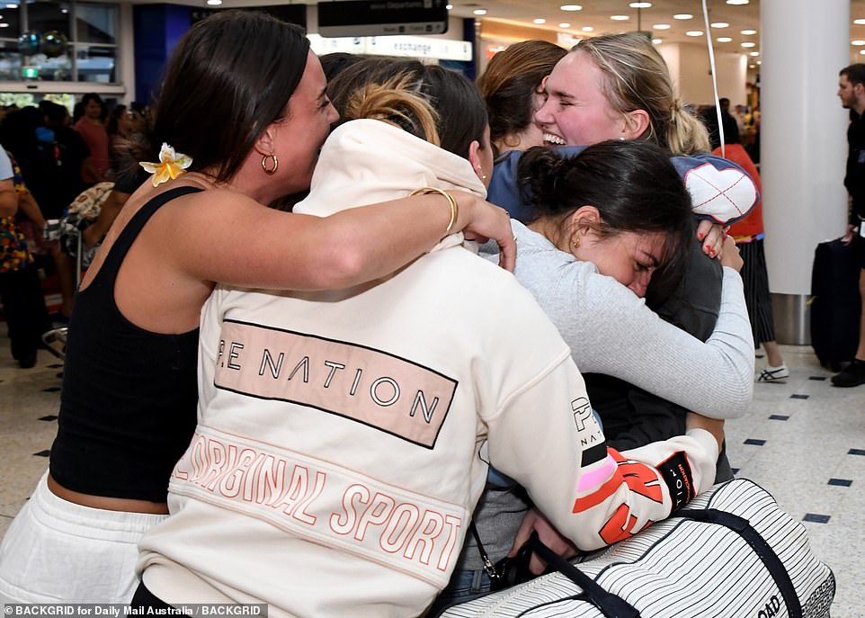 A young woman was tackled by her friends after landing in Sydney