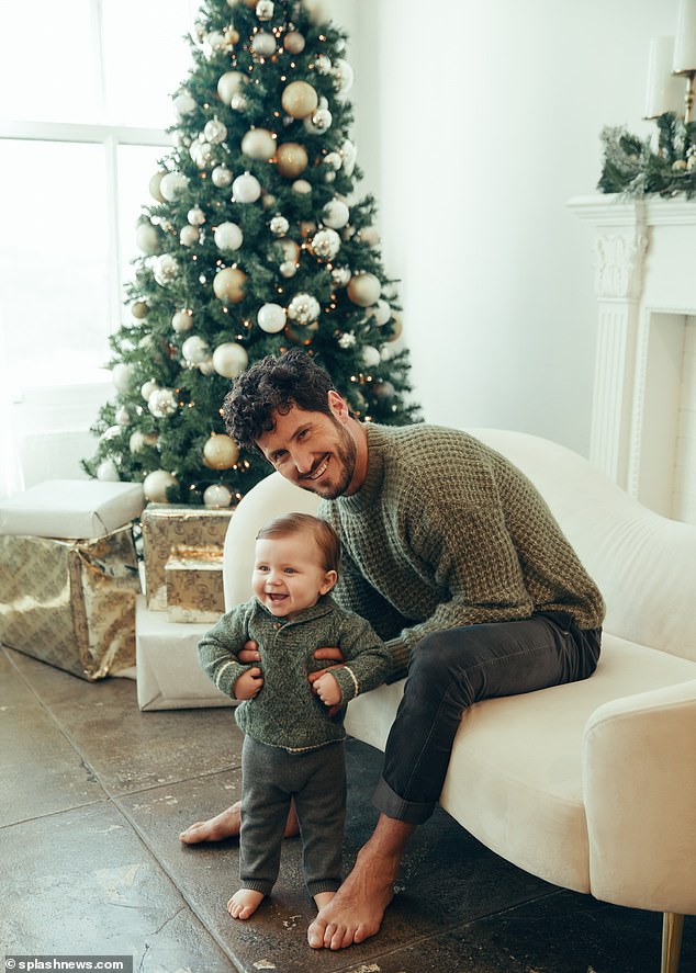 Val matched with his son as they posed in front of the tree