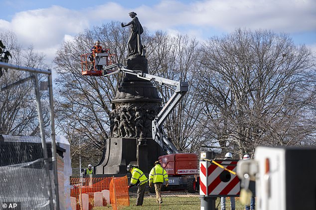 Officials began removing the structure Wednesday morning in front of a handful of onlookers, and a crane was used to lift the top of the Confederate monument