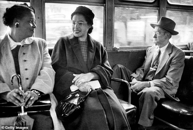 American civil rights activist Rosa Parks (center), riding a newly integrated bus following a Supreme Court ruling that ended the successful 381-day bus boycott of segregated buses in Montgomery