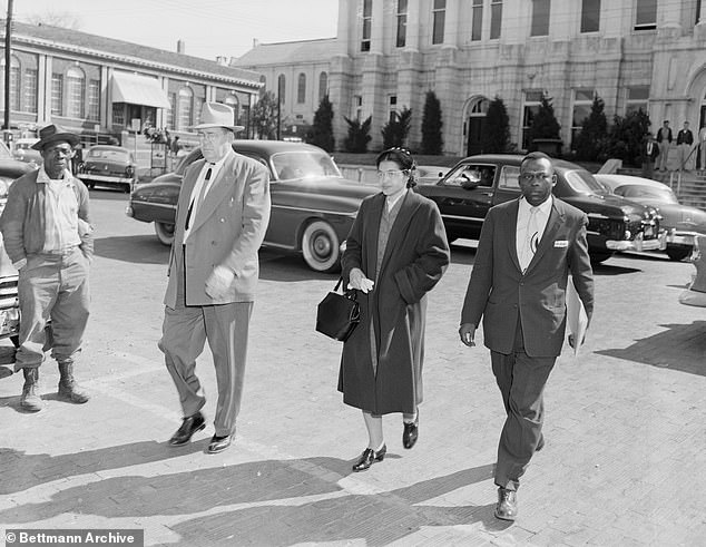 Rosa Parks (center), accompanied by her attorney, Charles D. Langford (right), and an unidentified sheriff's deputy, is on her way to jail.  She is arrested on charges of violating city segregation laws that sparked a citywide boycott by Montgomery Negroes of the city bus line