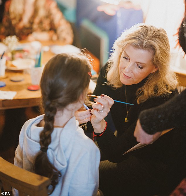 Duchess Sophie, 58, looked casual in a black turtleneck as she painted children's faces at The Lighthouse in Woking, Surrey