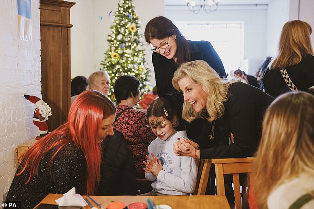 Sophie got involved in a festive face painting event, drawing reindeer antlers on a delighted young girl