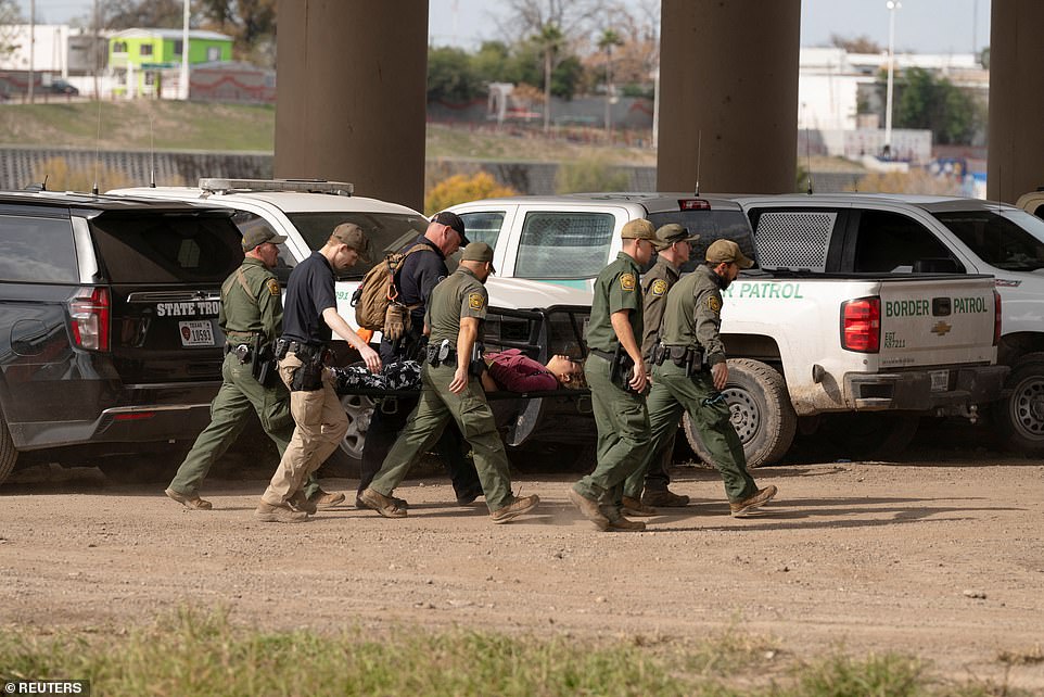 One migrant woman was taken away on a stretcher by Border Patrol agents after needing medical care