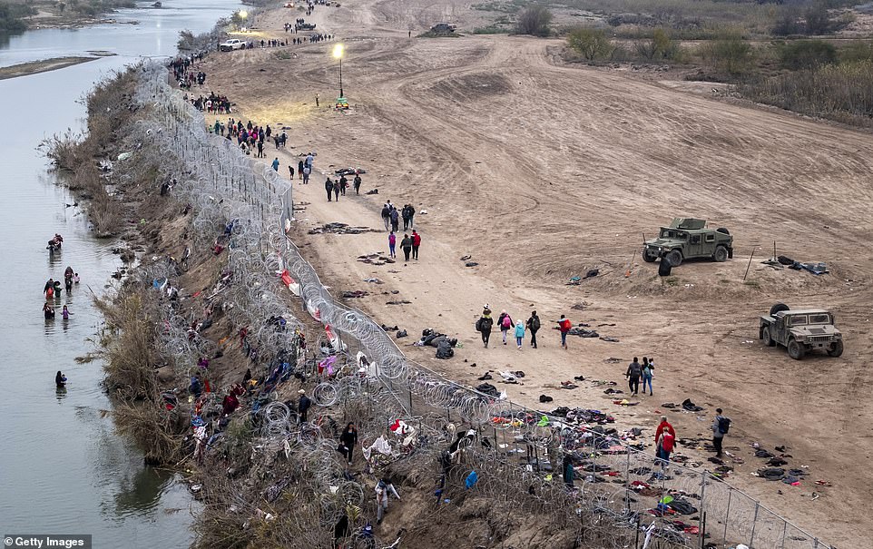 An aerial view of immigrants walking toward a U.S. Border Patrol processing center after wading through the Rio Grande from Mexico early December 20