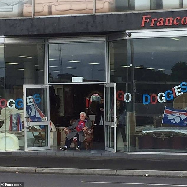 Franco Cozzo sits outside his Footscray store ahead of the AFL finals.  He was a crazy Western Bulldogs supporter
