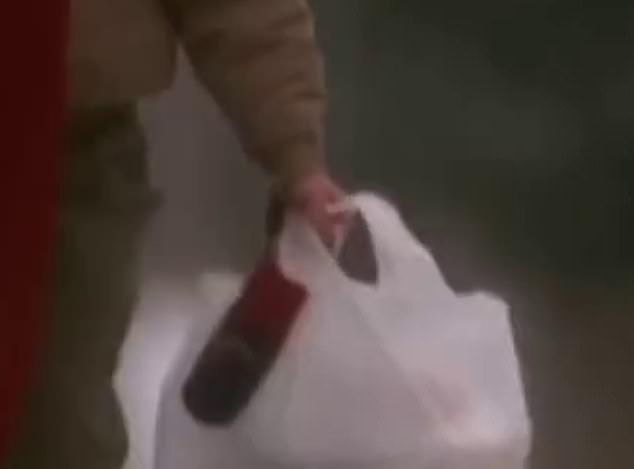 If you look closely, you'll see Culkin holding a string between the handles of the shopping bag