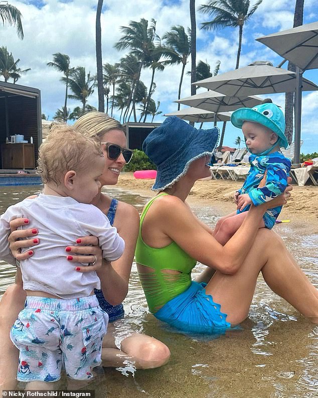 The couple has not yet revealed their son's face or name;  seen with older sister Paris Hilton and her son Phoenix in March