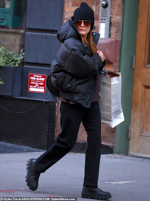 The Academy Award-winning actress, who recently reunited with one of her old costars, wore a slightly oversized puffy jacket on top of a pink crew-neck sweater.