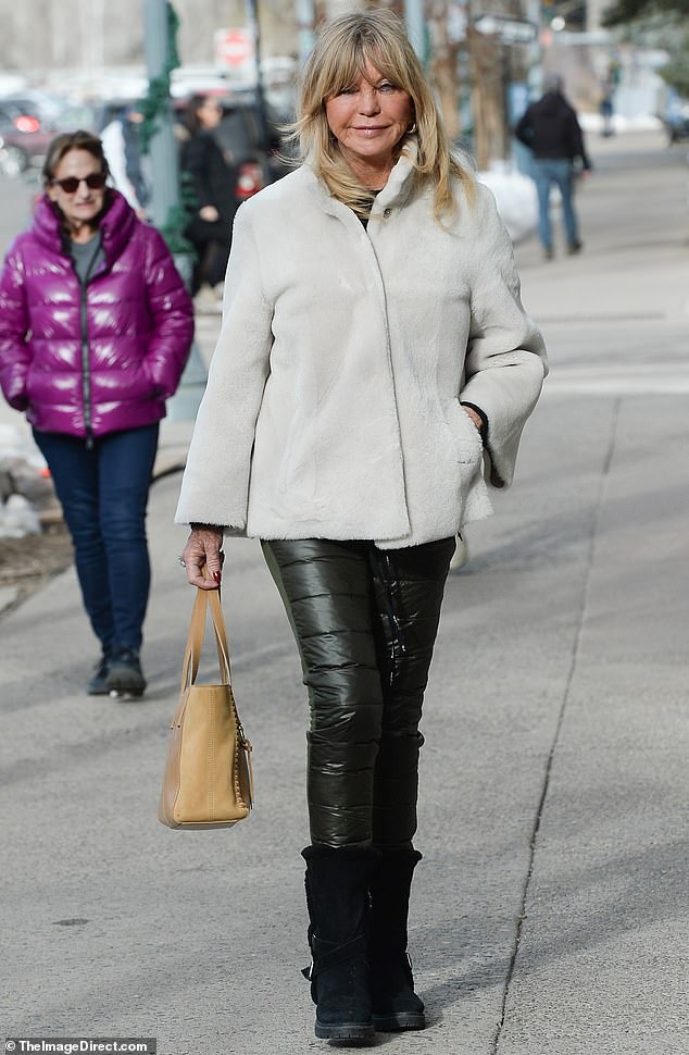 The actress, who was recently spotted trick-or-treating with her granddaughter, wore a white faux fur button-up coat over a black long-sleeved top as she went for a walk.