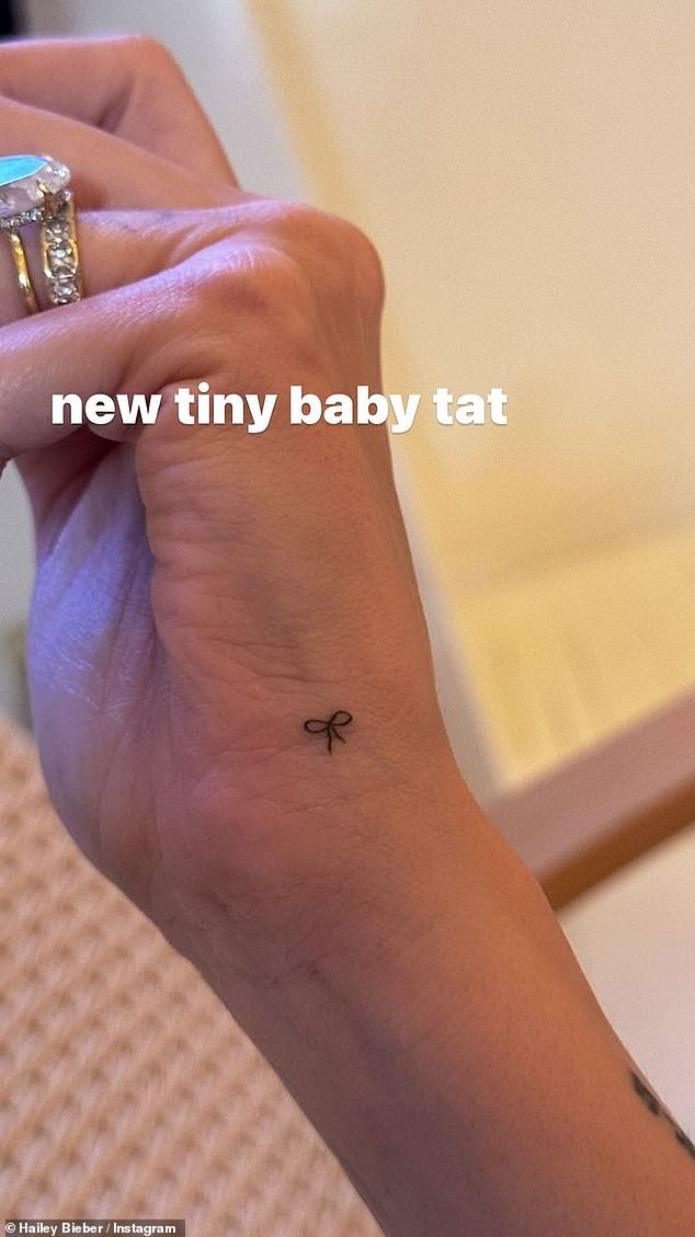 The 27-year-old model revealed she had a 'new little baby tat' and showed off the delicate, precise bow that now adorns the outside of her right hand and wrist