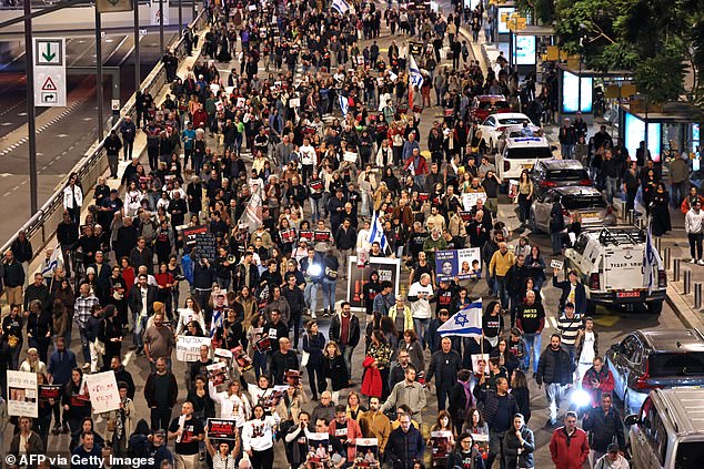 The deaths of the three hostages sparked anger in Israel, with demonstrators marching last night to share their fear and anger.  Pictured: Relatives and supporters of hostages held by Palestinian militants demonstrate outside the Israeli Ministry of Defense in Tel Aviv