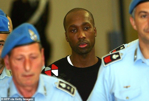 Rudy Guede leaves a court hearing in Perugia in September 2008.  He was imprisoned for Mrs Kercher's murder