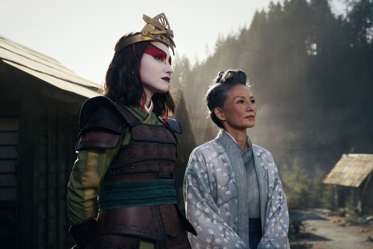 Suki from the live-action version of Avatar: The Last Airbender in full Kyoshi Warrior outfit, next to Mayor Yukari