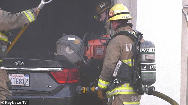 Rescuers used a circular saw to cut their way into one of the badly damaged cars