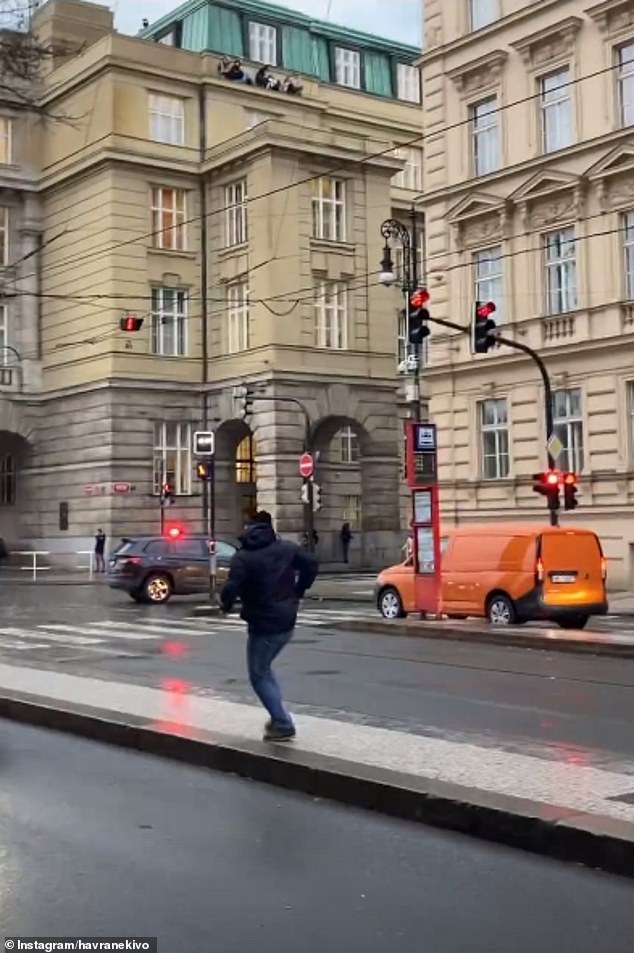 A man is seen sprinting through the center of Prague, while a group of students hide on the edge in the background