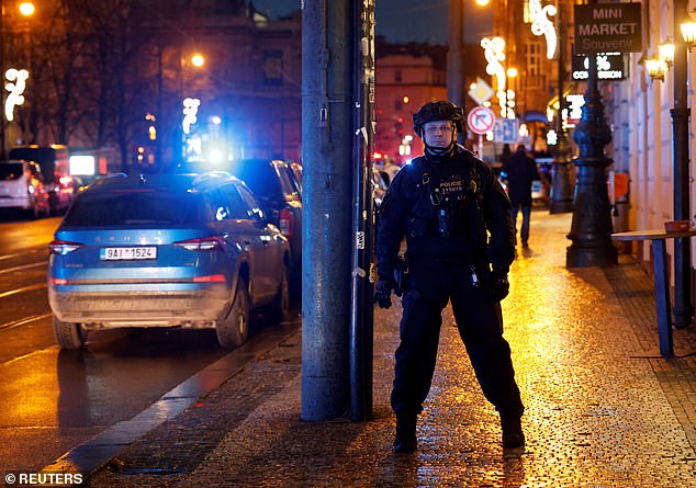 A police officer guards the area after Thursday's shooting in one of the buildings of Charles University in Prague