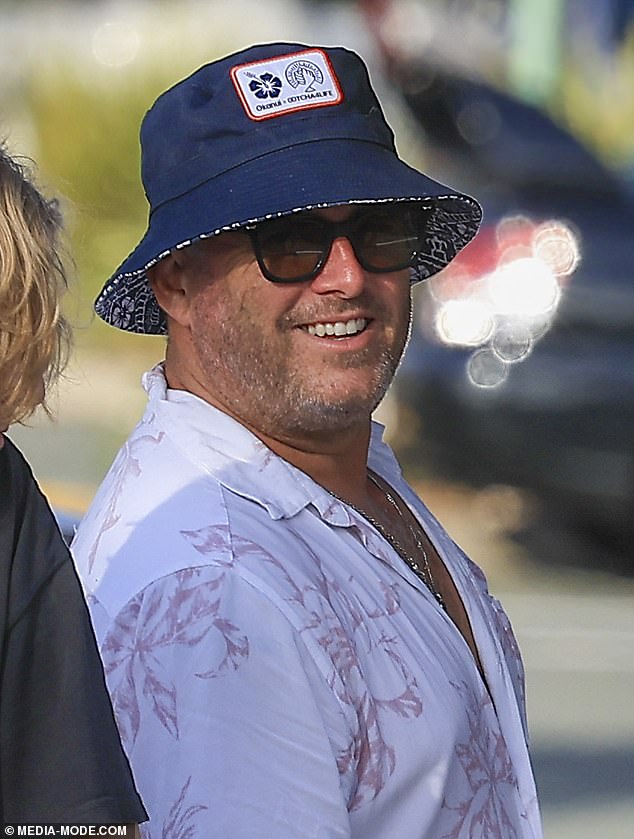 Karl looked decidedly festive, wearing Christmas-inspired board shorts and a white floral shirt that he wore loosely buttoned.