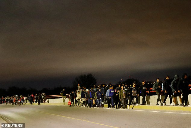 Migrants walk in a caravan intending to turn themselves in to U.S. Border Patrol agents, in Piedras Negras, Coahuila, Mexico, December 21