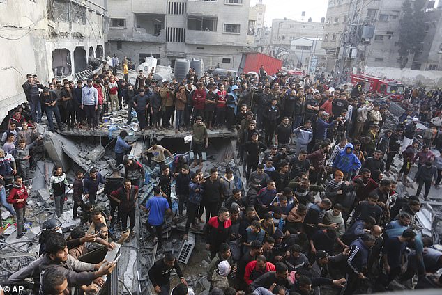 Palestinians look at the destruction after an Israeli attack in Rafah, Gaza Strip, on December 20
