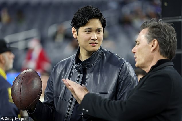 Ohtani normally throws a slightly smaller ball, but was seen wearing a pigskin on the sideline