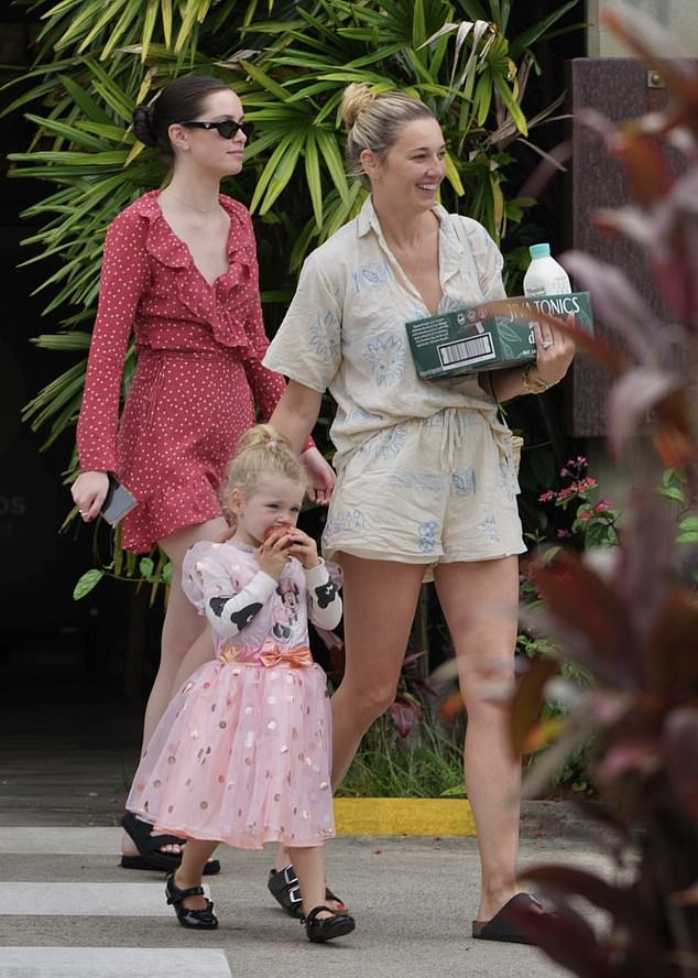 While Karl and Jasmine's three-year-old daughter Harper (pictured centre) looked adorable in a pink princess dress as she was sweetly escorted to the car by her mother and half-sister