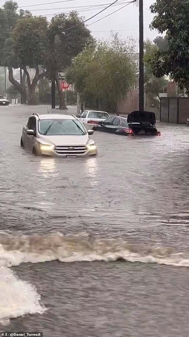 Counties northwest of Los Angeles County were also hit overnight, flooding areas in the cities of Port Hueneme, Oxnard and Santa Barbara, where a detective carried a woman on his back after the SUV they were in rode got stuck in knee-deep water.