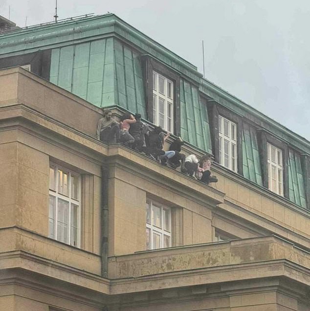 Other extraordinary footage shows terrified students cowering on a ledge high on a faculty in an attempt to hide from the gunman after others were told to barricade themselves in classrooms