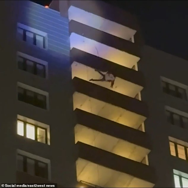 The man suddenly lost his grip and fell about 70 meters, landing on a structure above the first floor