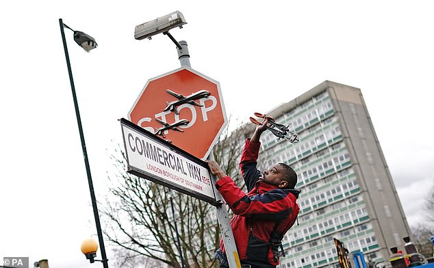 The pair were seen taking down the sign at the junction of Southampton Way and Commercial Way in Peckham at around 12.30am.