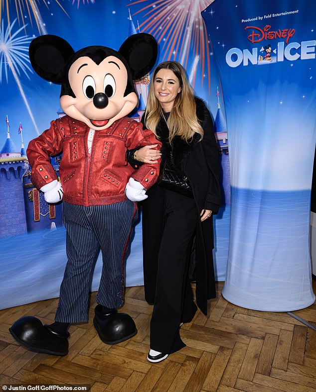 Former Love Island star Dani wrapped up warm in a long black coat and matching ensemble as she posed for a photo arm-in-arm with Mickey