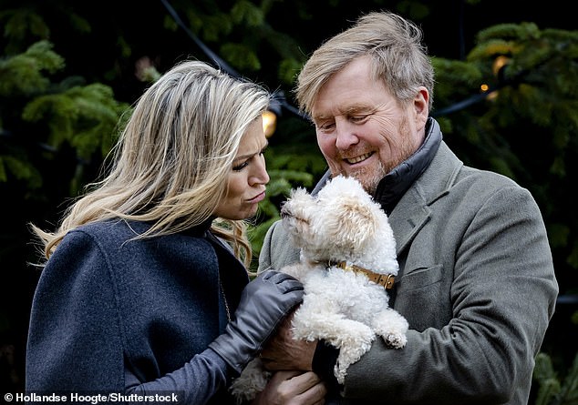 Queen Máxima frowned at her dog as he was held up by King Willem-Alexander