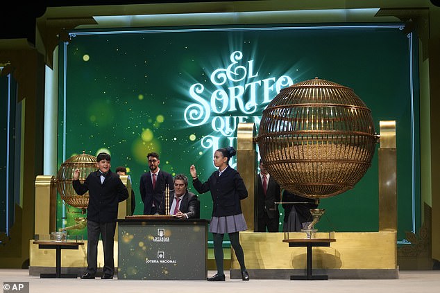 Children from San Ildefonso School in Madrid sing the numbers of one of the top prizes of awarded lottery balls at the Teatro Real opera house in Madrid during the Spanish Christmas lottery draw known as El Gordo, December 22