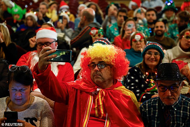 People in costumes wait for the start of the traditional Spanish Christmas lottery draw "El Gordo" (The Fat One), at Teatro Real, in Madrid, Spain, December 22